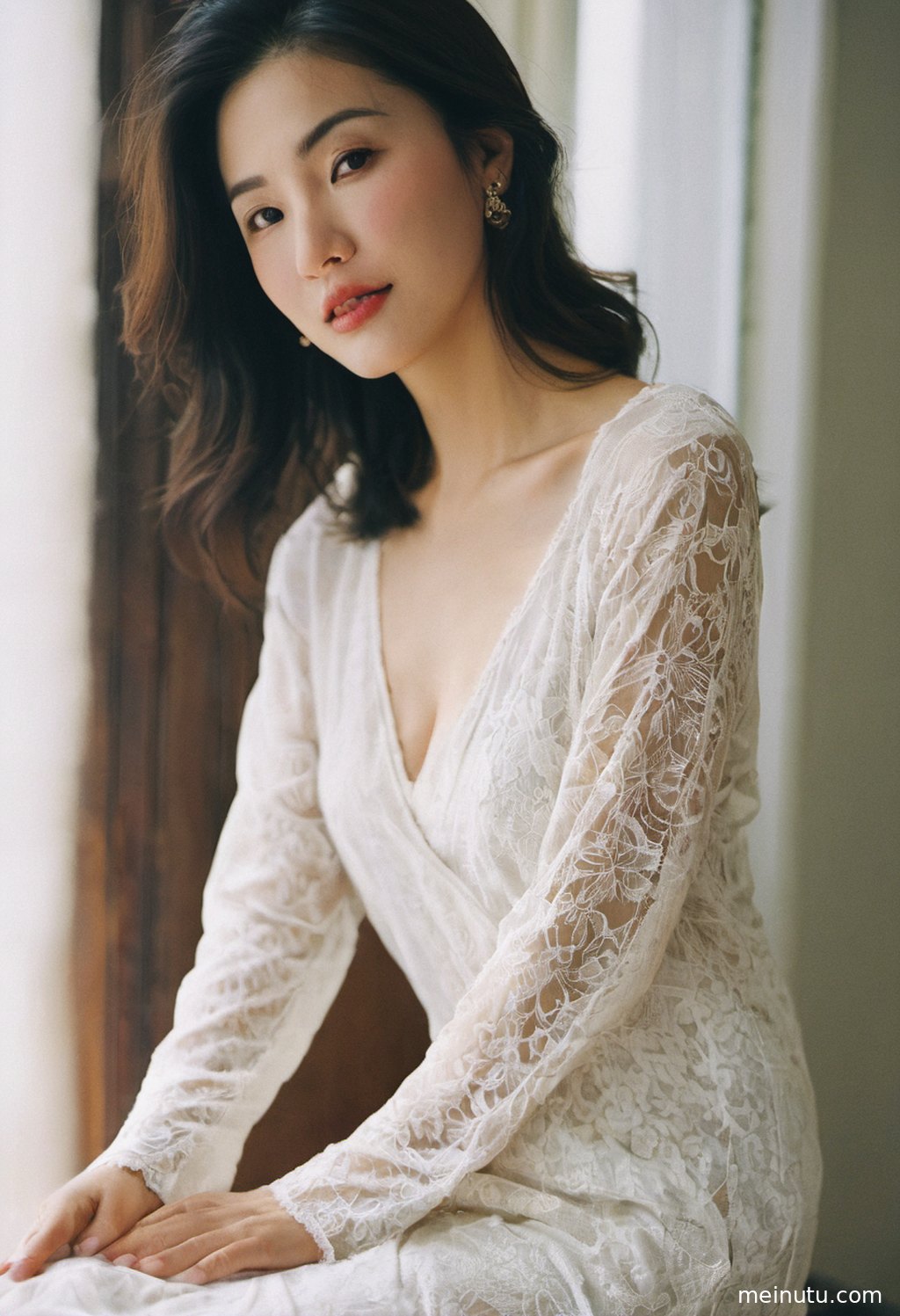 An Asian adult woman in stylish casual clothing looks back under warm side light on a quiet street.